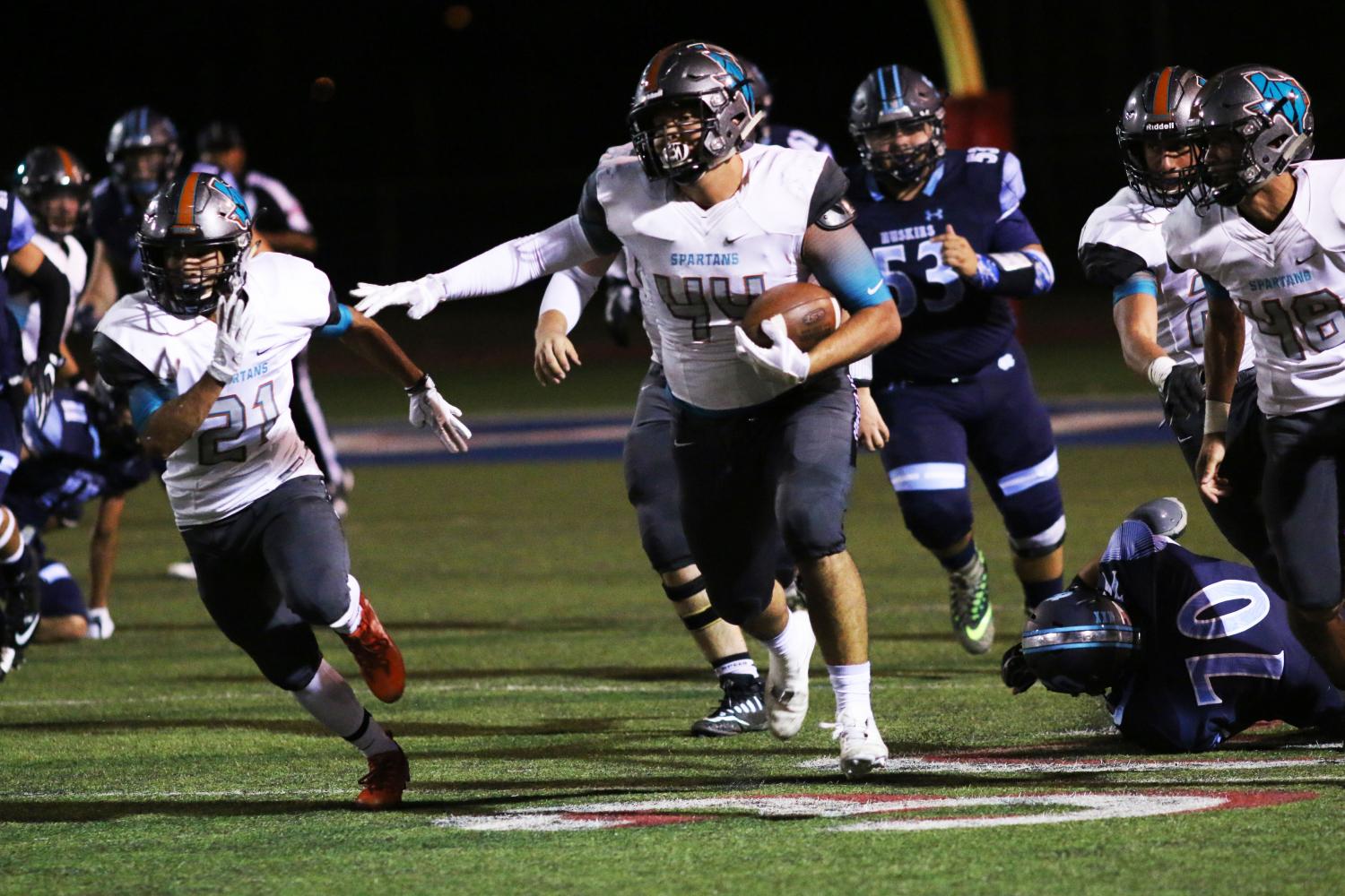 After recovering a fumble, Kevin Esquivel returns the ball for a touchdown as the Spartans defeat No. 2 Chapin, 31-14. 