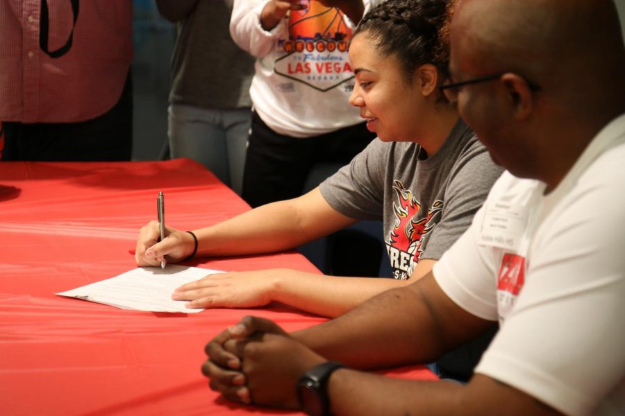 Thalia Watters signs her letter of intent early Tuesday morning. 