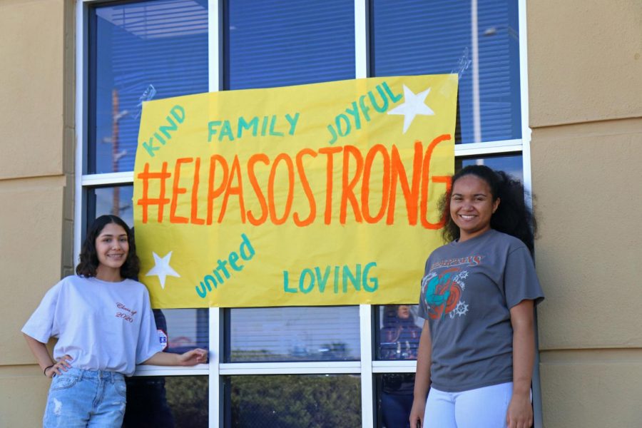 Senior Estefania Muniz (left) and senior Angelica Littles (right) stand in front of an El Paso Strong poster at Vitalant Saturday Aug. 10. 