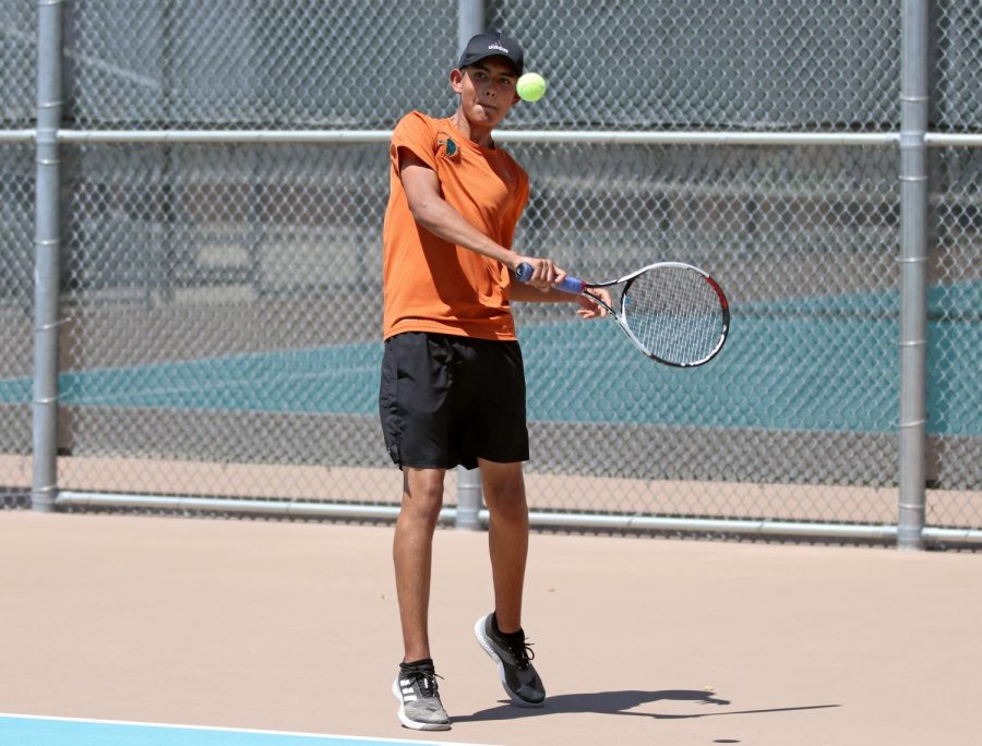 Senior and tennis captain Diego Rodriguez smacks it back to his opponent during the Aug. 27 match against Socorro.