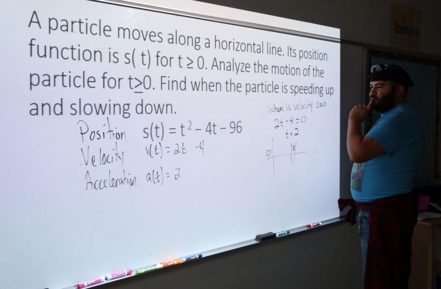 Calculus teacher, Francisco Aguilar, working through an example for his AP calculus class. 