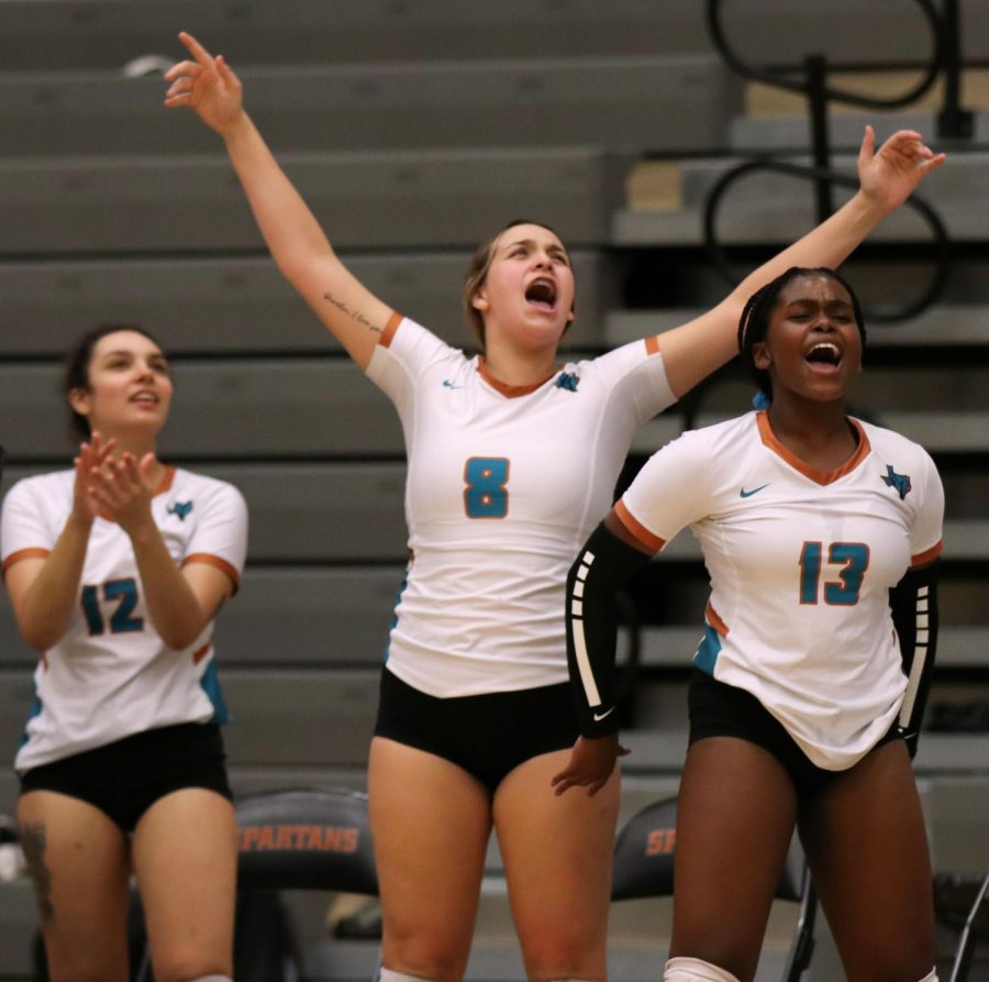 Seniors Jenavie Sanchez, Paige Hopper and Nyla Hyman cheer for the Spartans as they defeat El Dorado Tuesday night Aug. 31. Photo by Natalie Rojas