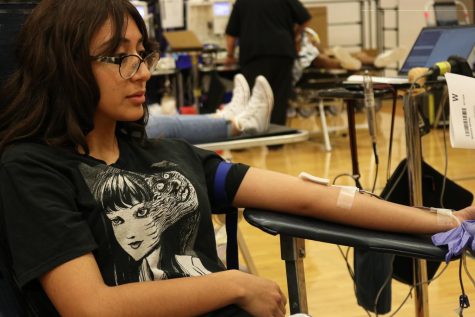 Senior Marissa Medina donates blood in the small gym Friday morning Aug. 19.