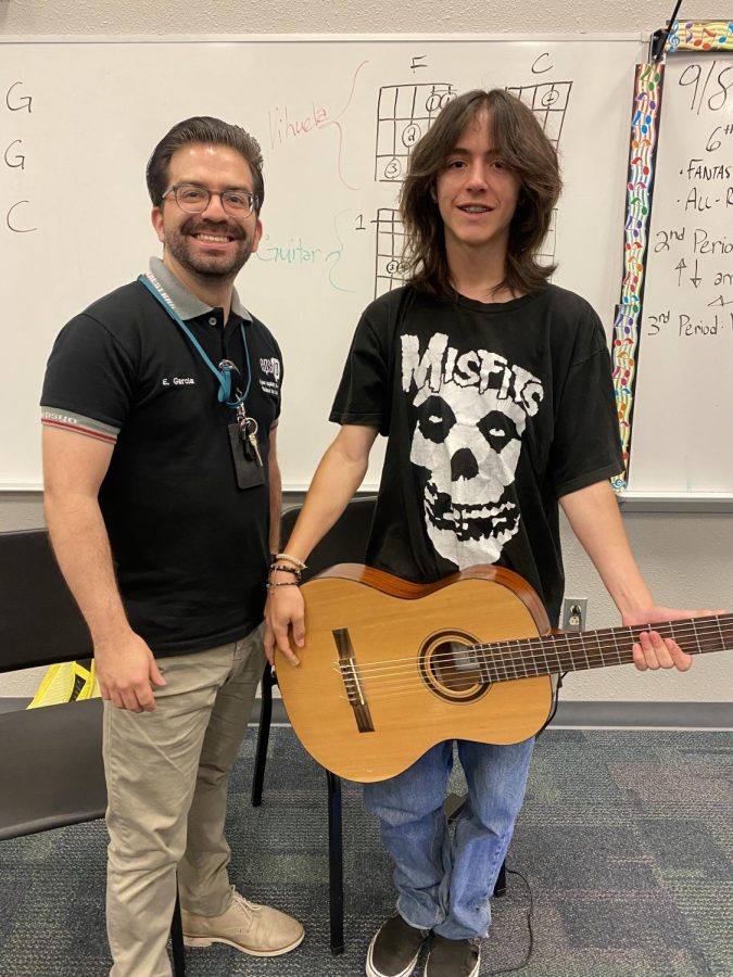 Sophomore Nick Myers poses next to Mr. Garcia Thursdsy afternoon, eager to learn about music.