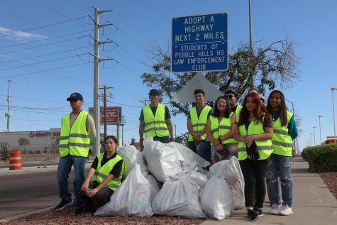 Law enforcements students stand in front of their sign after cleaning up the highway Saturday morning Oct. 1. Photo by Haley Monroy 