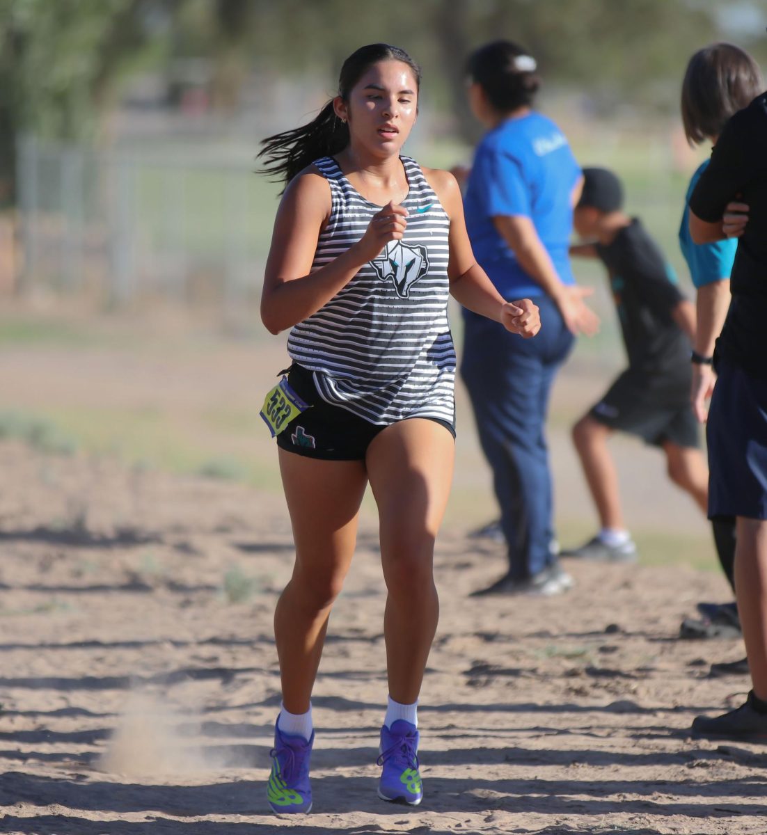 Senior Carolina Zarrabal runs in the Canutillo Invitational on Saturday morning Aug. 19. Photo by Isabel Sandoval 