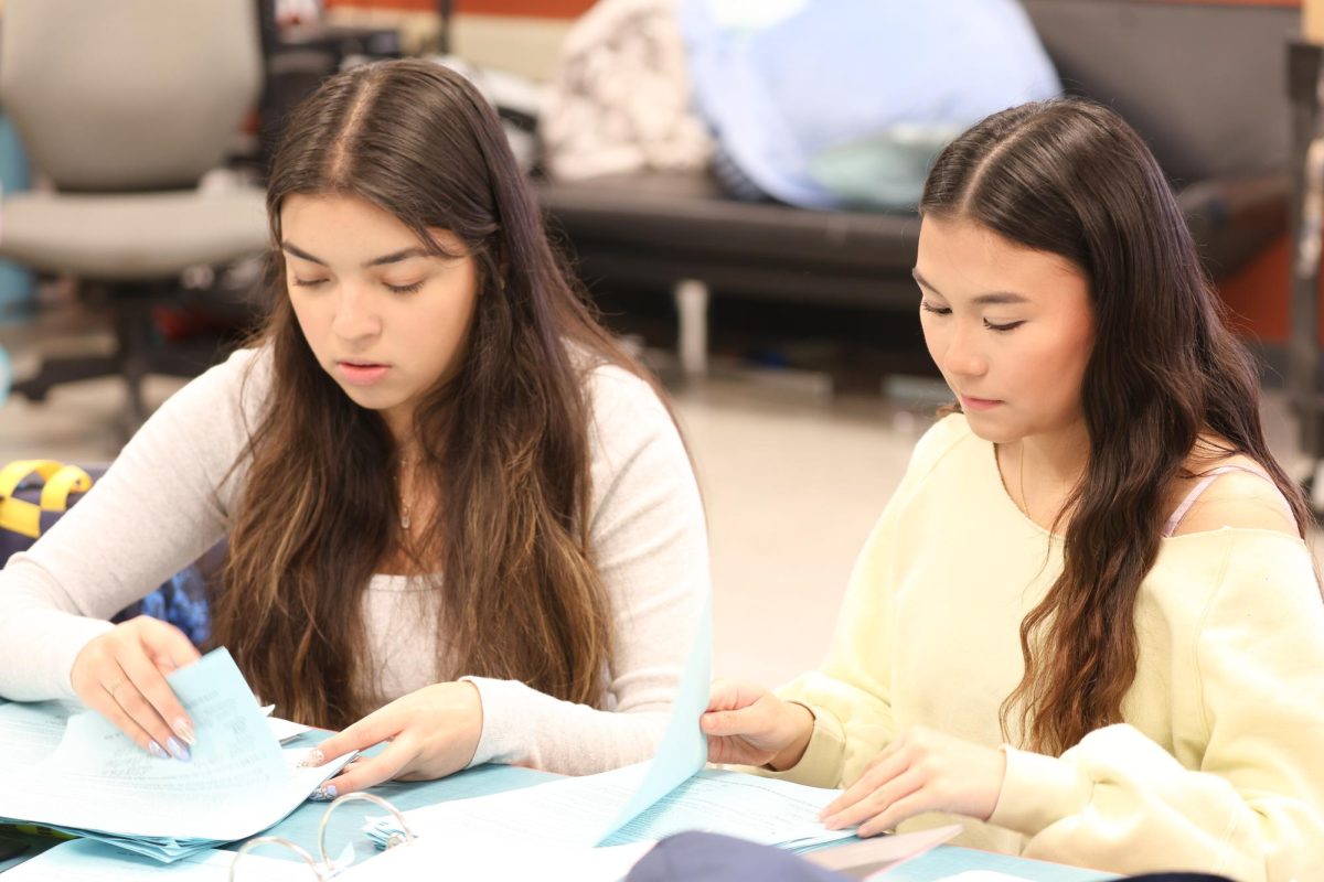 Vice president Julianne Rios and  President Sharene Mercado make decorations Tuesday morning, April 21. Photo by Evan Oberg 